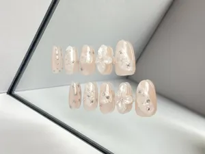 Handmade press-on nails nude medium long gentle style with 3D flowers and silver stars.