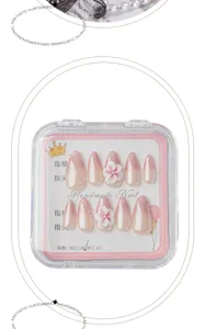 Handmade press-on nails detail view, featuring elegant pink gradient and 3D floral accent.