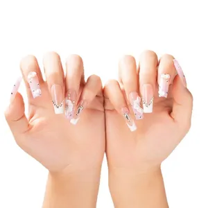 Uñas postizas hechas a mano degradado rosa blanco con estrás flores largas y elegantes.