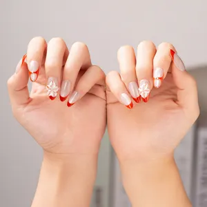 Handmade press-on nails with red French tips, 3D floral art and sparkling rhinestones.