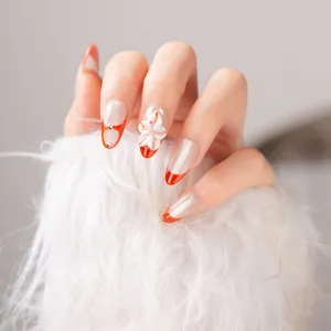Handmade press-on nails with red french cat eye and 3D floral design main view.