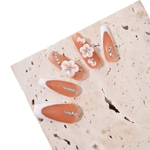 Sweet 3D floral press-on nails set with elegant rhinestone and French tip design.