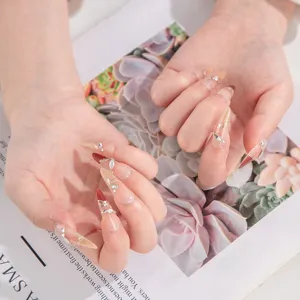 Handmade press-on nails with rhinestones and gold wire, medium-long stiletto style for luxury.