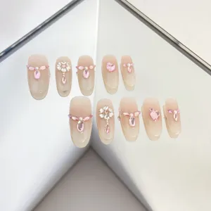 Handmade press-on fake nails with pink rhinestones and pearls for women daily wear.