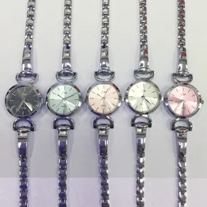 Detail view of stylish quartz women watches with metal link straps and multi-colored round dials.