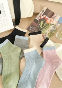 Women's striped cotton mid-tube socks with contrasting color design for daily wear, fresh style.