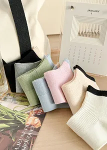 Detailed view of casual pastel vertical striped cotton socks featuring stylish contrast cuffs.