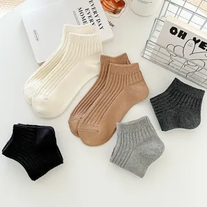 Detailed flat lay shot of solid color ribbed low-cut ankle socks in multiple colors.