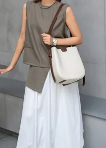 Detailed view of the stylish leather bucket bag with contrast brown trim, ideal for commute.