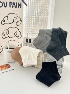 Detailed view of casual ribbed short socks in various colors displayed neatly on wire rack.