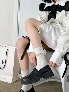 Cute white lace JK bow mid-tube socks for women, sweet Lolita cotton daily hosiery detail.
