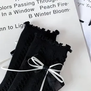 Japanese JK style black mid-calf socks featuring elegant white ribbon bow for cute daily outfits.