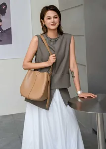 Detailed view of a stylish leather bucket bag showcasing fine craftsmanship and modern design.