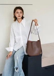 Vintage genuine leather bucket bag for women, stylish brown shoulder bag for commuting.