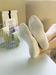 Detailed close-up shot of women breathable cotton low cut boat socks with cute grip sole print.