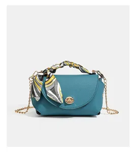 Teal leather crossbody shoulder bag with chain strap and chic scarf. Perfect for daily wear.