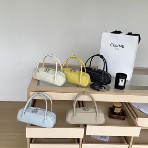 Detailed view of stylish cylindrical leather top handle bags in multiple chic colors for daily use.