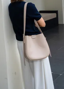 Leather vintage bucket bag detailed shot showcasing elegant beige leather and stylish design.