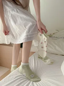 Floral green cotton socks detail showing cute print, pastoral style, soft and breathable fabric.