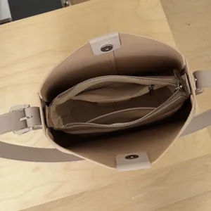 Interior detail view of genuine leather bucket shoulder bag with zipper compartment.
