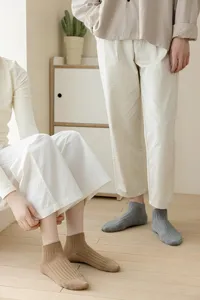 Close-up detail of breathable solid color ribbed ankle socks worn in casual daily scene.