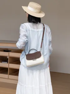 Elegant leather handbag with contrast flap, perfect for casual daily wear and versatile styling.