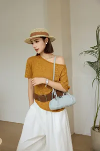 Detailed view of the light blue leather underarm bag styled with casual autumn outfit.