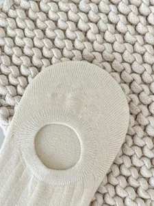 Detailed view of women's beige breathable invisible boat socks with soft knit texture.