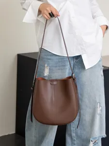Stylish brown leather bucket bag for women, classic retro shoulder bag with adjustable strap.