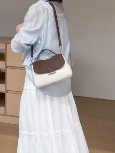 Genuine leather women handbag, brown white contrast shoulder crossbody bag detail view.