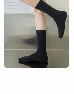 Detailed view of women's black mid-calf socks, made of soft cotton, comfortable elastic cuff.