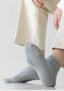 Detailed shot of breathable mesh men's short socks in light gray for comfortable daily wear.