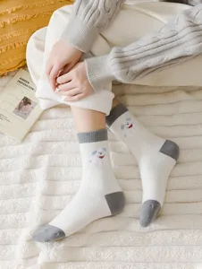 Winter thickened warm wool women socks with cute puppy cartoon pattern contrast color design.
