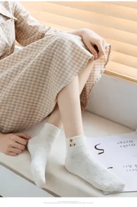 Detailed view of white cotton low-cut socks featuring cute bear embroidery and subtle letters.