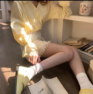 Detailed view of the stylish white mid-tube socks paired with chic outfit for daily wear.