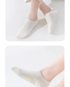 Close-up detail view of women's breathable pure cotton white ribbed shallow boat socks.