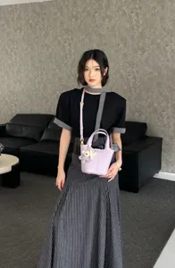 Stylish genuine leather bucket bag for women, elegant purple shoulder and crossbody handbag.