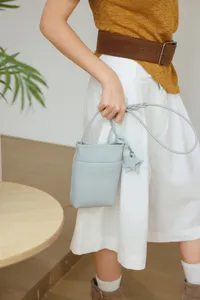 Genuine leather mini crossbody phone bag with stylish star charm for women. Perfect daily accessory.