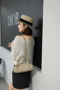Elegant genuine leather underarm bag with double handles and minimalist retro baguette style.