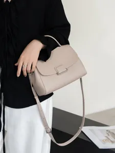 Minimalist leather shoulder bag, elegant grey handbag with metal clasp for daily wear.