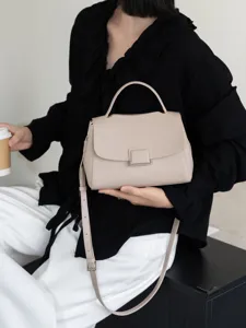 Elegant leather top handle crossbody bag for women, minimalist daily shoulder bag design.
