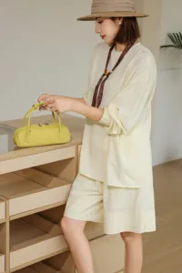Detailed view of women's genuine leather baguette shoulder bag in stylish yellow color.