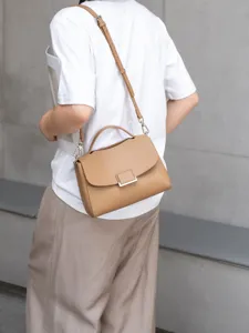 Chic genuine leather women's shoulder bag with stylish top handle and minimalist flap design.