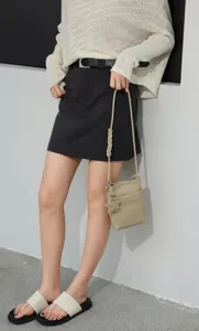 Genuine leather mini crossbody bag with braided strap and star charm for stylish women daily use.