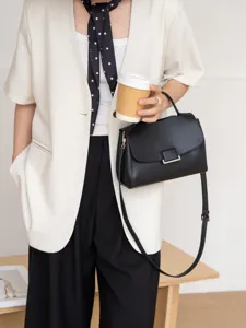 Stylish genuine leather women handbag, minimalist black cross-body shoulder bag for daily wear.