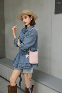 Genuine leather mini crossbody phone bag with star charm, detailed view of stylish wear.