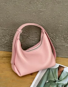 Detailed close-up view of the pink genuine leather hobo bag, showing fine texture and zipper.