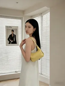 Genuine leather hobo bag for women, stylish yellow underarm shoulder bag for casual daily wear.