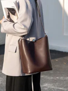Genuine leather brown bucket bag for women, elegant simple shoulder crossbody commuter bag.
