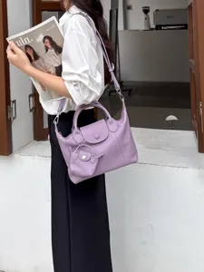 Purple genuine leather tote bag with shoulder strap and mini pouch charm for women daily use.